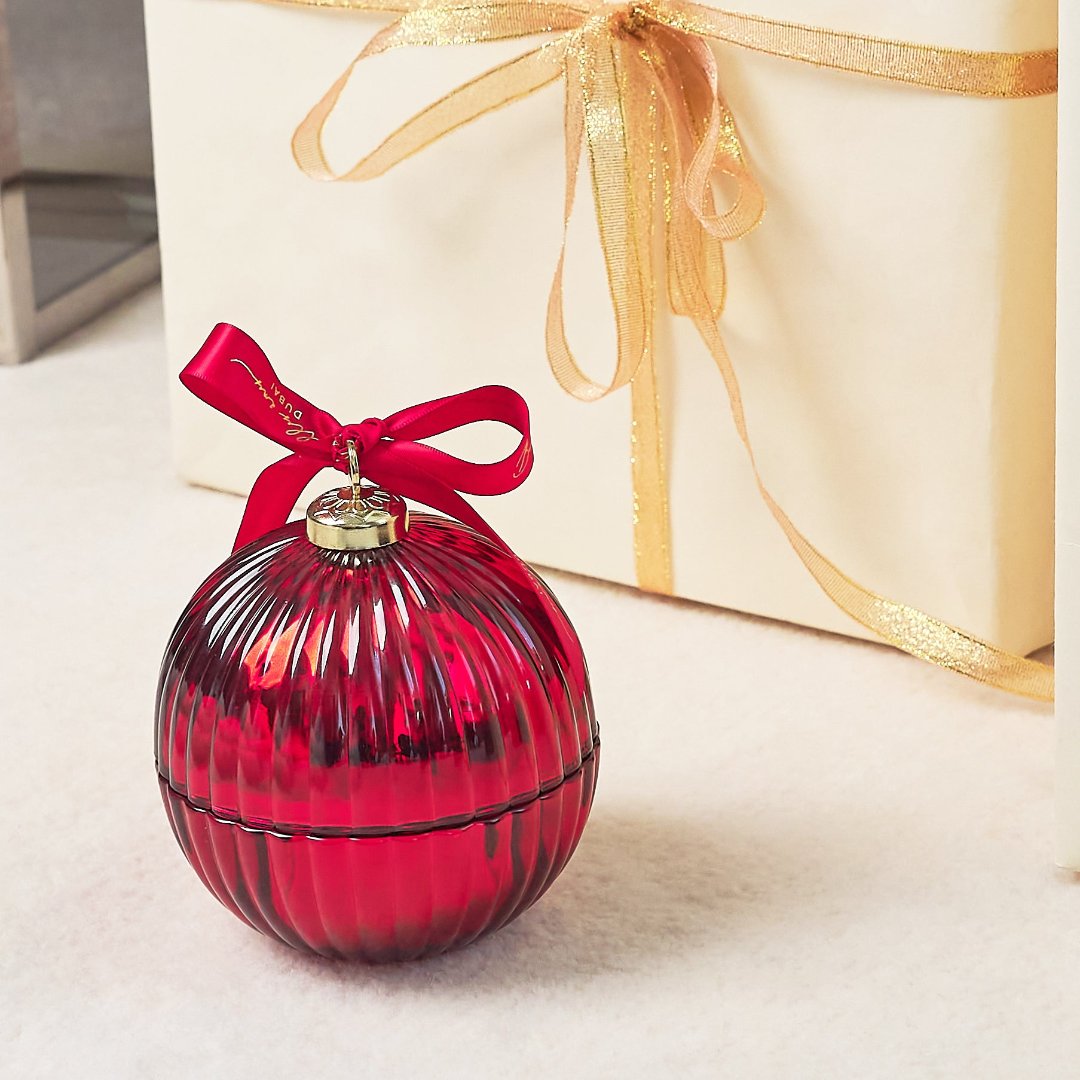 red bauble red ribbon and white and gold gift box